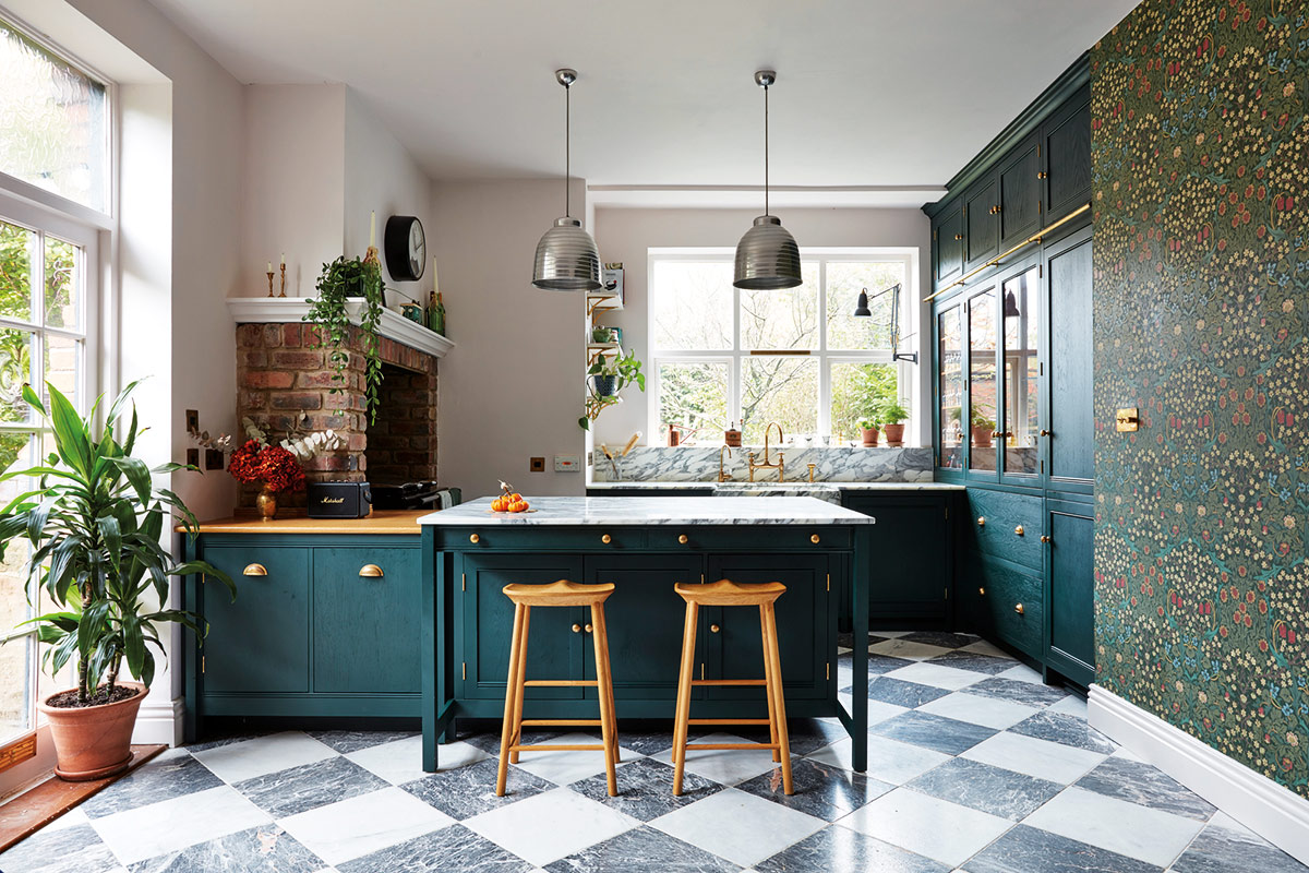 green Shaker kitchen design with marble flooring and patterned wallpaper
