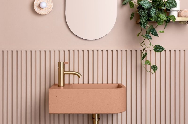 pink bathroom with concrete basin and wall panelling